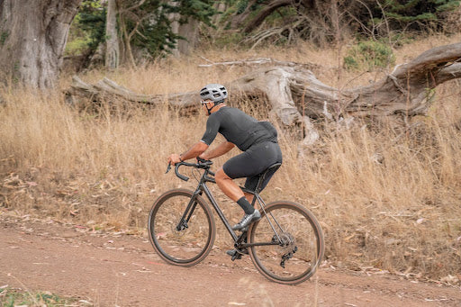 image of man riding a gravel bike with a suspension seatpost
